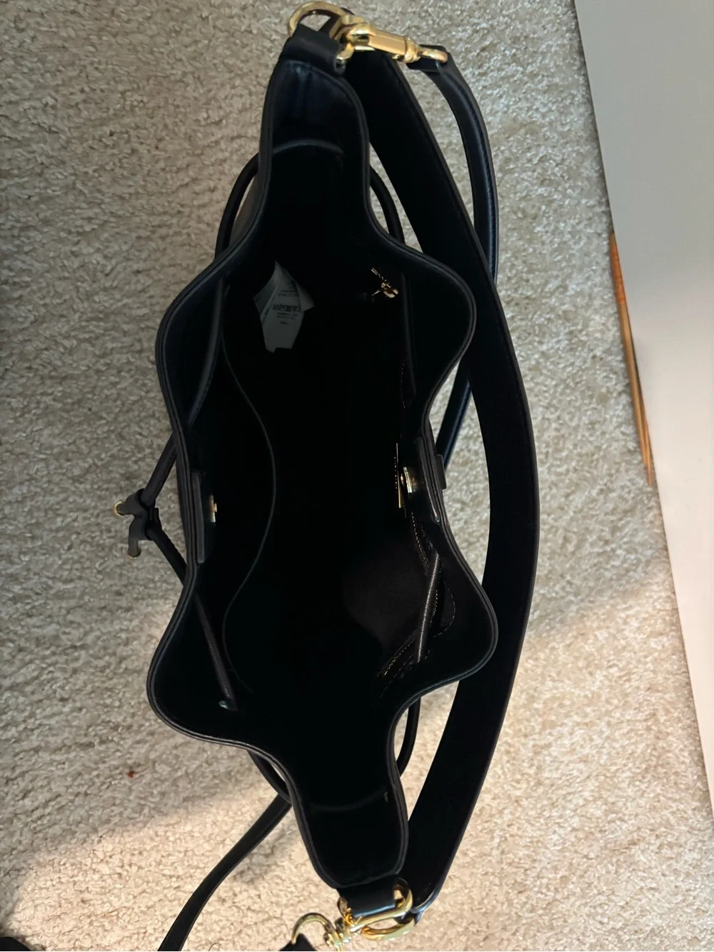 black leather drawstring bucket bag with shoulder or crossbody strap